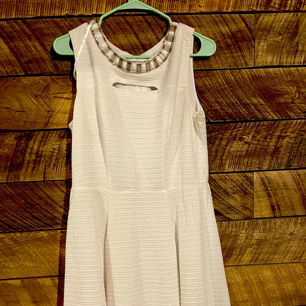 White dress with cutout and decorative neckline